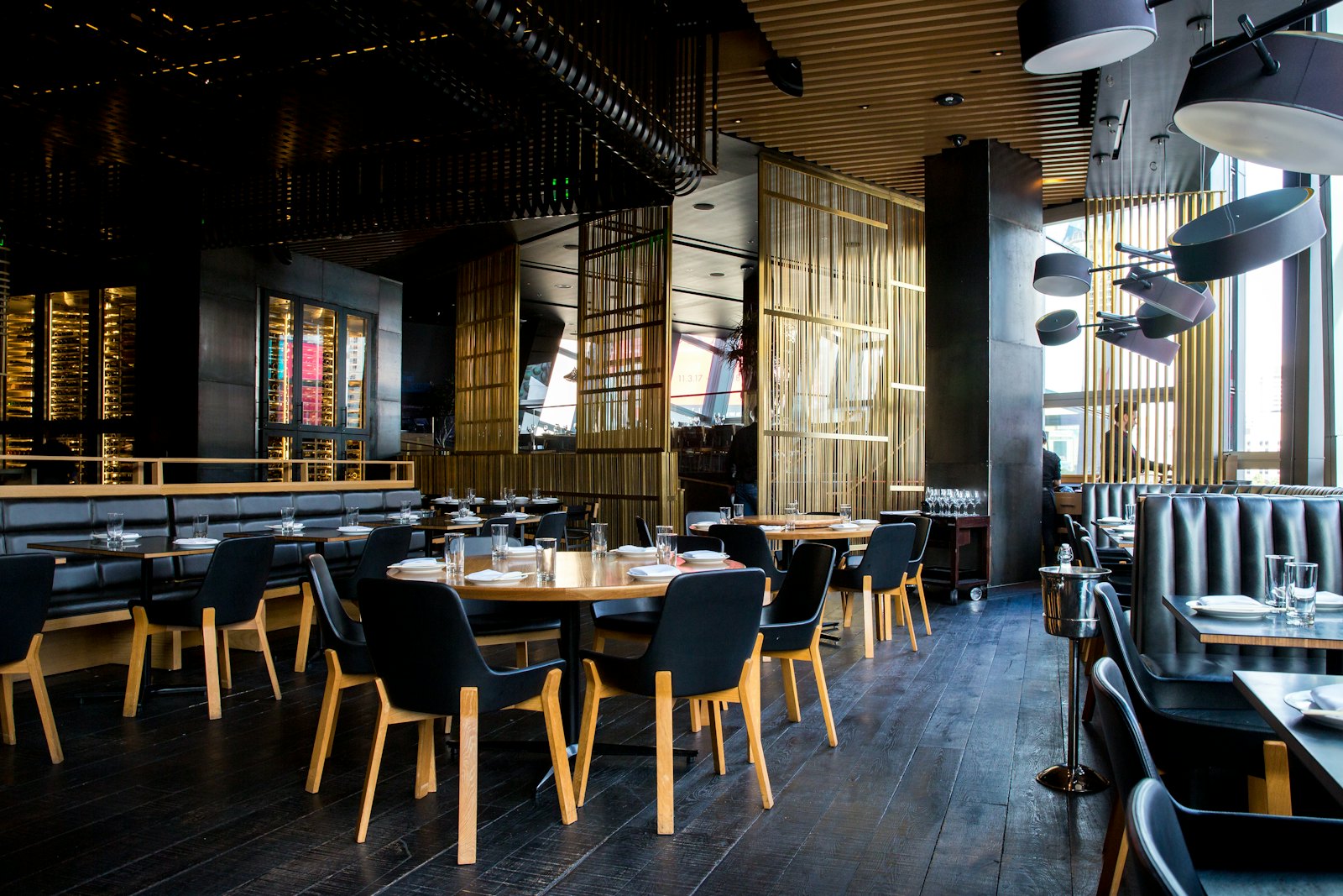 A warm, modern restaurant interior at night